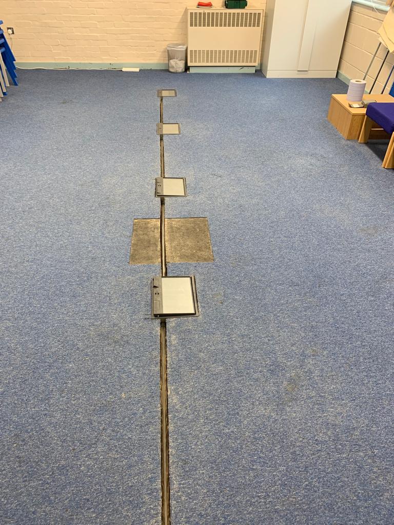 Floor cable-management route in an empty room