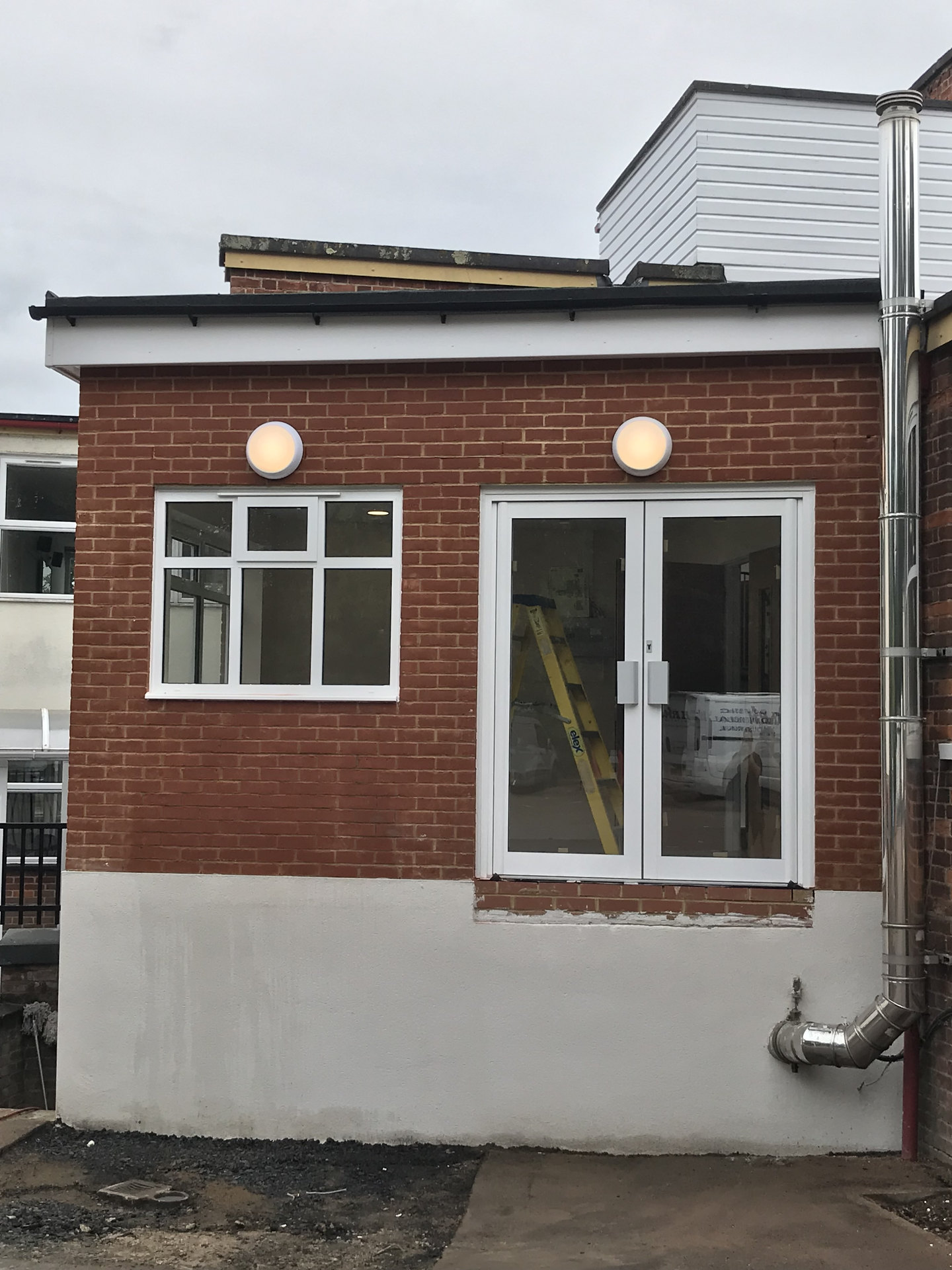 Exterior wall lights on a brick commercial building