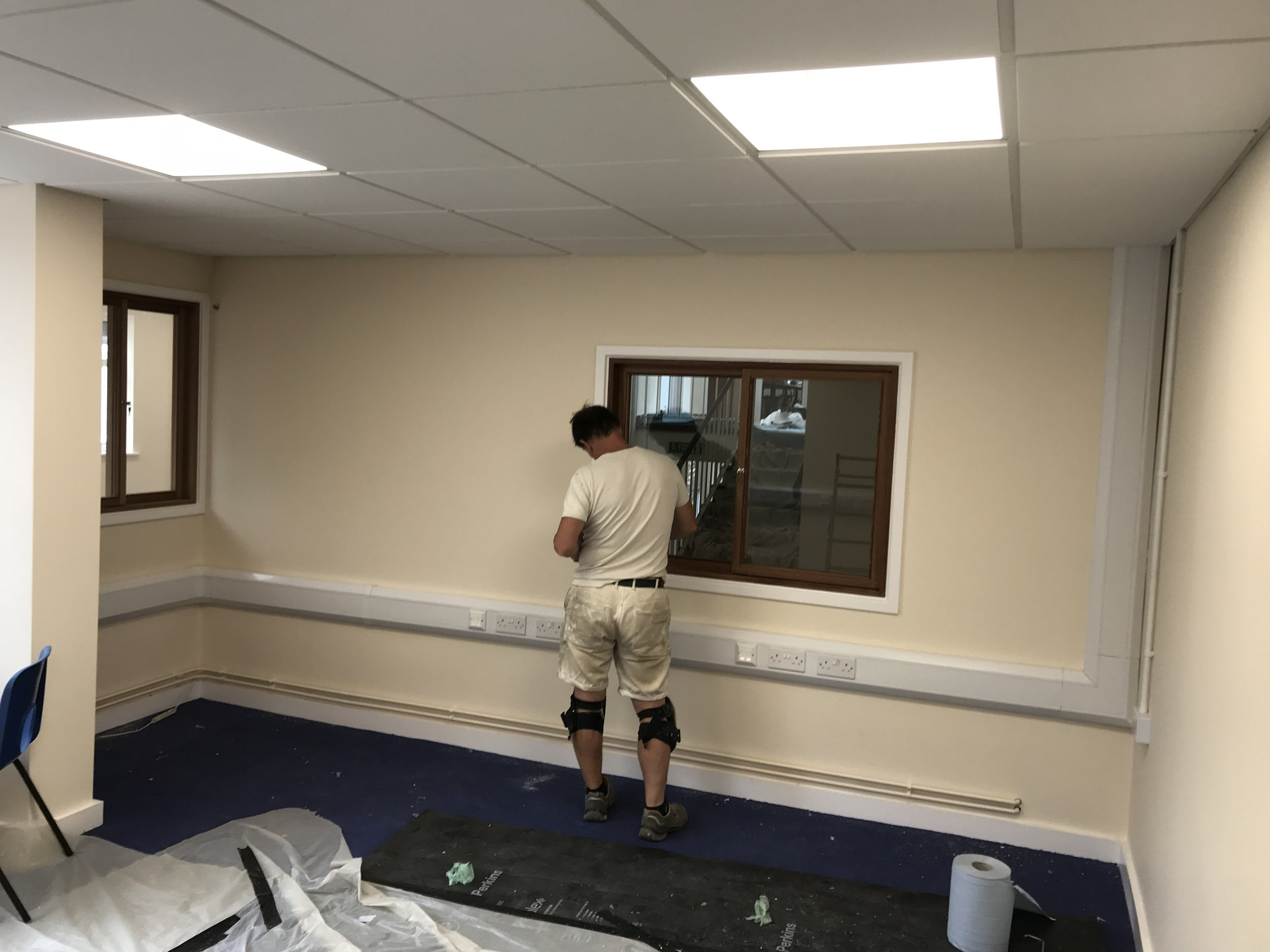 Commercial room with ceiling light panels and perimeter power outlets