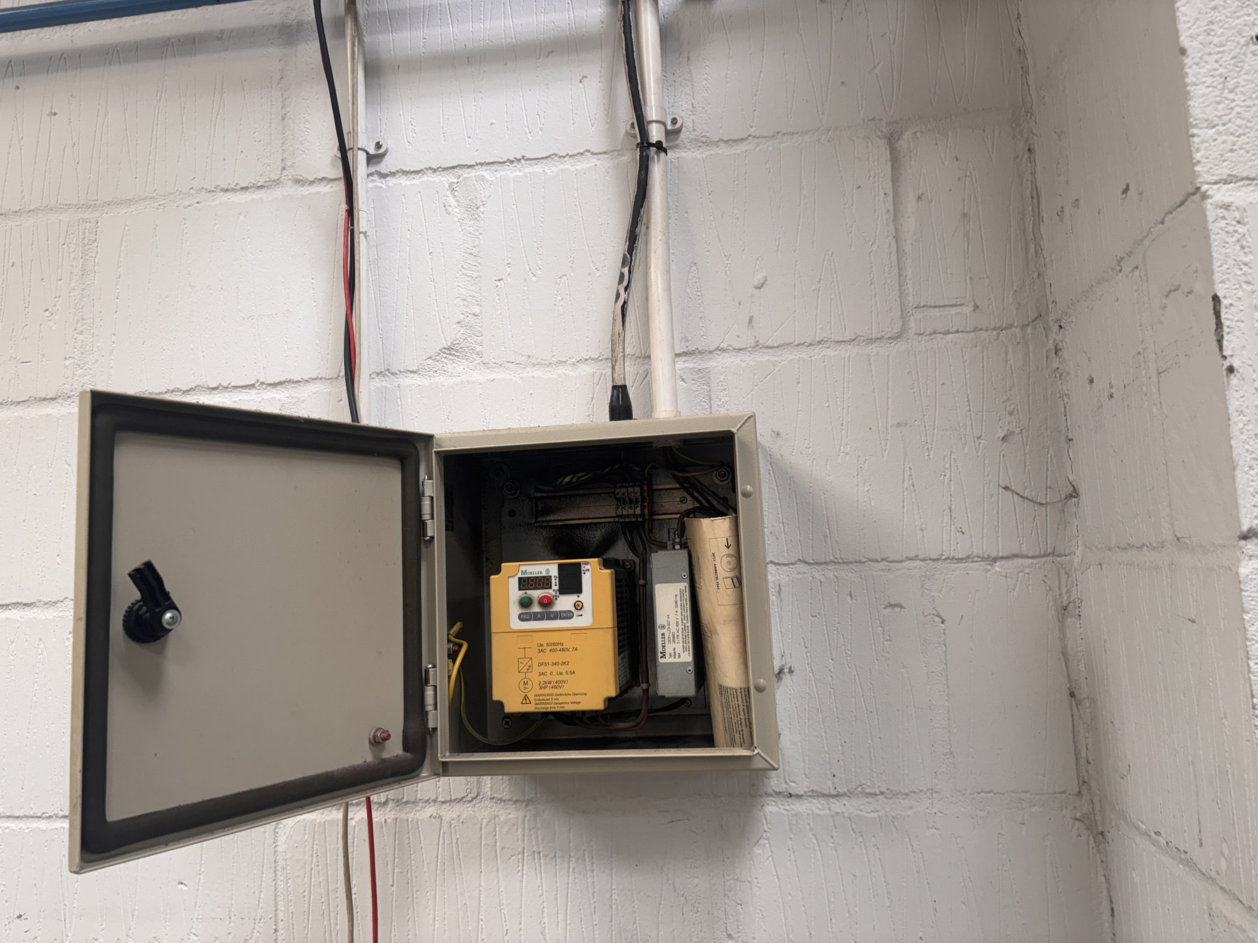 Wall-mounted electrical equipment in an industrial premises