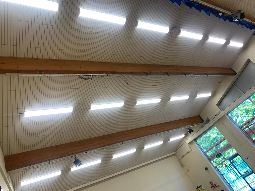 Ceiling-mounted lighting in a school hall