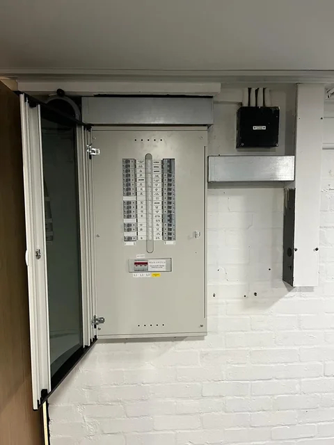 Open electrical cabinet in a corridor