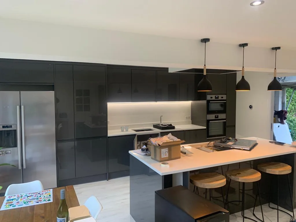Pendant and recessed lighting above a kitchen island